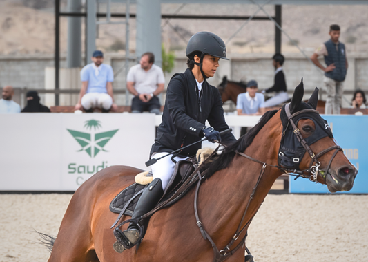Equestrian rider in competition at a Saudi event, showcasing skill and precision